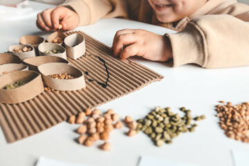 Montessori and Sensory Development, A child plays with natural materials and sorts cereals
