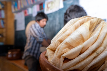 corn husks skillfully arranged to wrap Mexican tamales. concept traditional cooking.