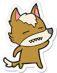 sticker of a cartoon wolf waving showing teeth