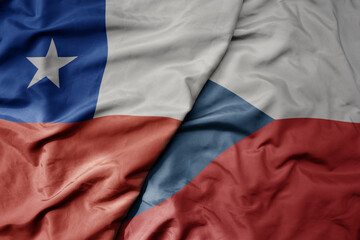 big waving national colorful flag of czech republic and national flag of chile .