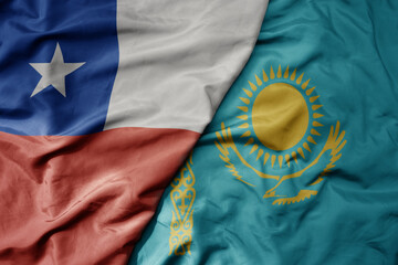 big waving national colorful flag of kazakhstan and national flag of chile .