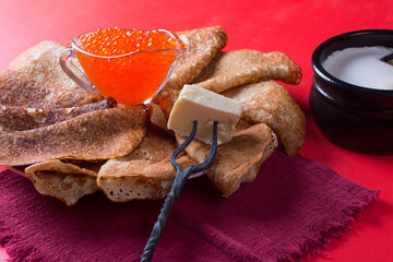 Maslenitsa holiday, pancakes with sour cream on the table. The Russian tradition
