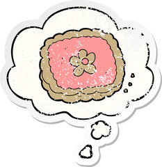 cartoon biscuit and thought bubble as a distressed worn sticker