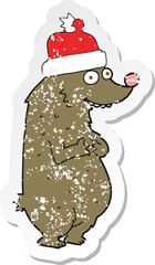 retro distressed sticker of a cartoon bear wearing christmas hat