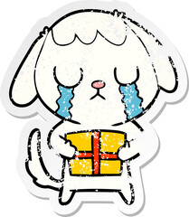 distressed sticker of a cute cartoon dog with christmas present