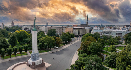 Fototapeta na wymiar Beautiful sunrise view over Riga by the statue of liberty - Milda in Latvia. The monument of freedom.