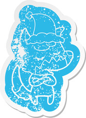 friendly cartoon distressed sticker of a fox wearing santa hat