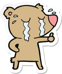 sticker of a cartoon crying bear