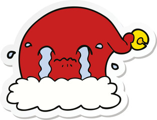 sticker of a cartoon christmas santa hat crying