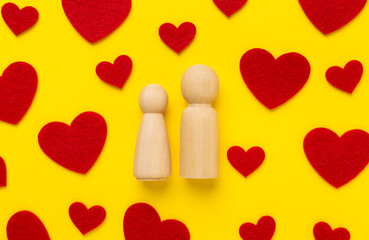 Wooden couple in love on color background, top view. Creative valentine's day composition