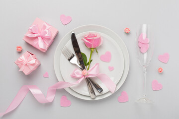 Fototapeta na wymiar Festive table setting for Valentine's Day on color background, top view