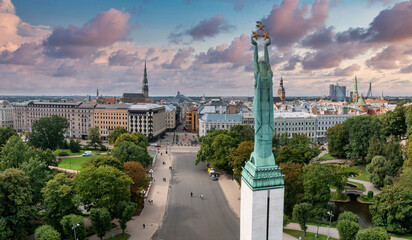 Beautiful sunrise view over Riga by the statue of liberty - Milda in Latvia. The monument of...