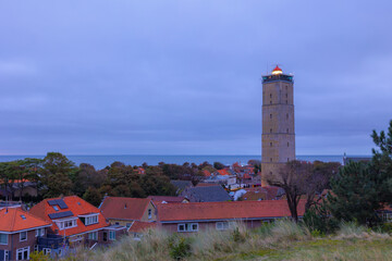 Fototapeta na wymiar Small town in West-Terschelling in evening, Brandaris lighthouse (Vuurtoren Brandaris) on the Dutch Wadden Sea island Terschelling, A municipality and an island in the northern, Friesland, Netherlands