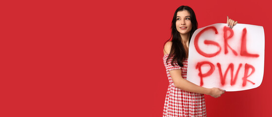 Young woman holding placard with slogan GRL PWR on red background with space for text. Feminism...
