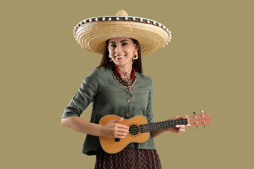 Beautiful woman in sombrero hat and with guitar on green background