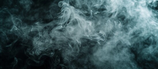 Obraz premium Selective focus and toning create a cloud of smoke on a black background.