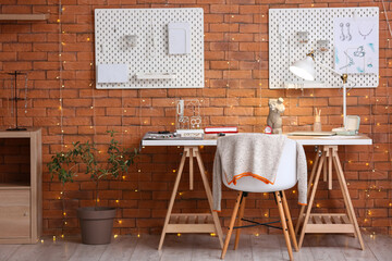 Interior of workshop with jeweler's workplace, pegboards and glowing lights