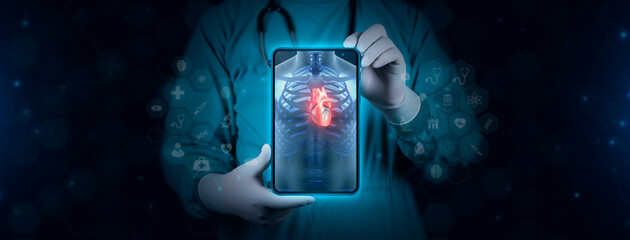 The doctor analyzes the cardiac angiography. Doctor with tablet shows chest x-ray. The human heart is observed focused. Technological digital background
