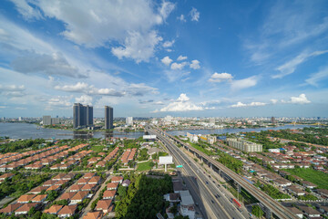 Aerial view of Bangkok Downtown skyline, highway roads or street and Chao Phraya River in Thailand. Financial district in smart urban city. Skyscraper and high-rise buildings.