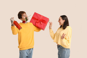 Young man greeting his beloved girlfriend with Valentine's day on white background
