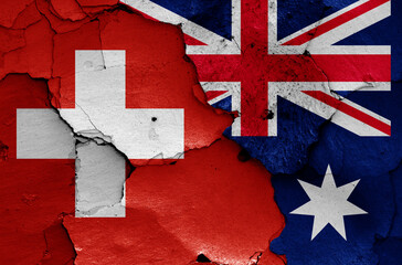 flags of Switzerland and Australia painted on cracked wall