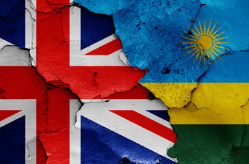 flags of UK and Rwanda painted on cracked wall