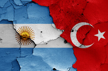 flags of Argentina and Turkey painted on cracked wall