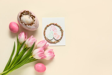 Composition with greeting card, tulips and eggs on white background. Easter celebration