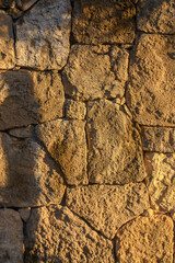 wall made of real stone as a background in the sun 4