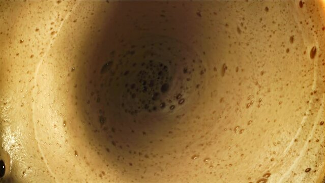 Foam with black coffee. Top view. Filmed on a high-speed camera at 1000 fps. High quality FullHD footage
