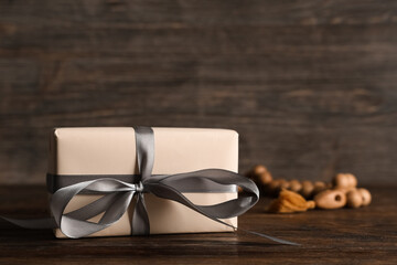 Gift box with prayer beads for Ramadan on wooden table