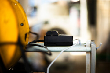 power bank and power cables on a table in a factory, shallow depth of field