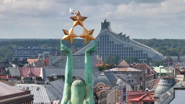 Beautiful sunrise view over Riga by the statue of liberty - Milda in Latvia. The monument of freedom.