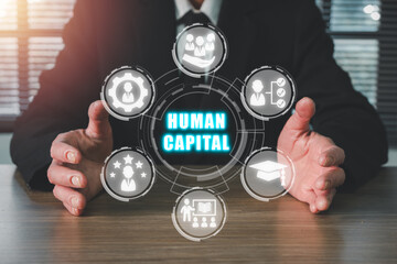 Human capital concept, Businessman hand holding human capital icon on virtual screen. Production...