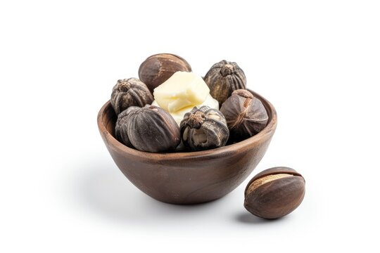 Isolated white background with shea nuts and butter cream in bowl