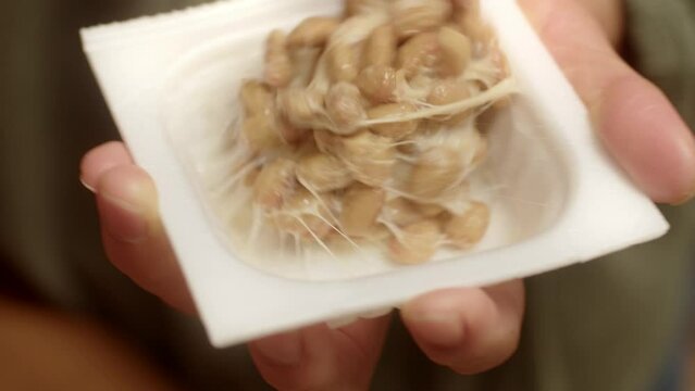 Japanese woman preparing natto beans