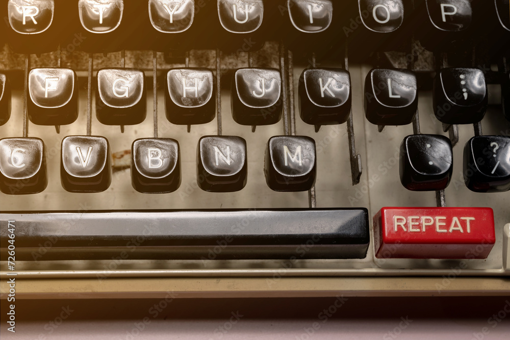 Poster text of repeat on a vintage typewriter button