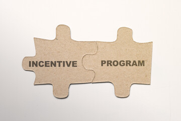 Two pieces of a jigsaw puzzle with incentive program text