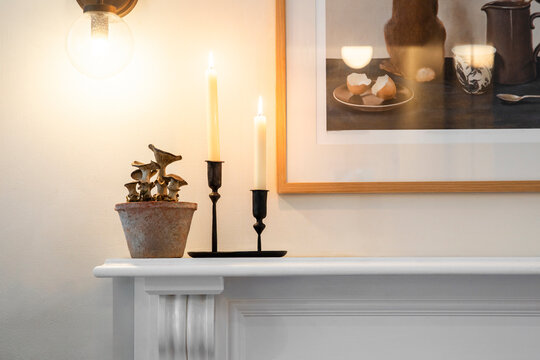 Oyster Mushrooms in a Ceramic Pot, Candles Burning on a White Wooden Shelf
