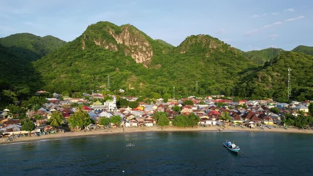 Gorontalo, Indonesia: Cinematic aerial drone footage of leato selatan village just outside Gorontalo by the Celebes sea in the Sulawesi island in Indonesia. 
