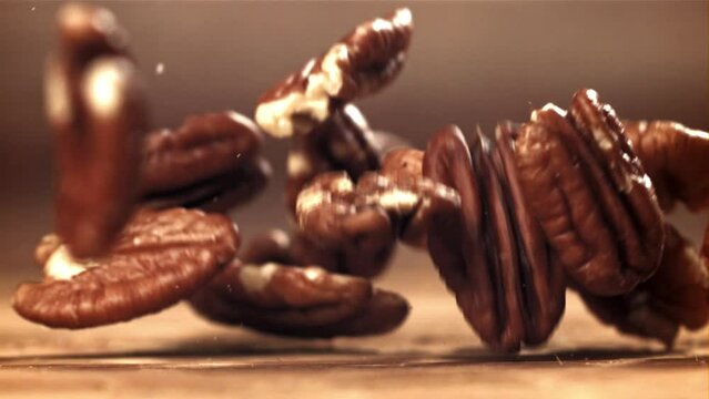 Pecans fall on the table. Filmed on a high-speed camera at 1000 fps. High quality FullHD footage