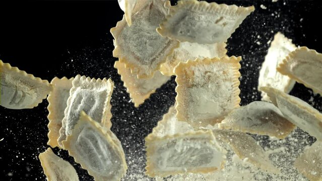 Italian ravioli fly up and fall down with flour. Filmed on a high-speed camera at 1000 fps. High quality FullHD footage