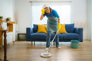 Housekeeper  Fatigued While Cleaning the Floor in the Living Room