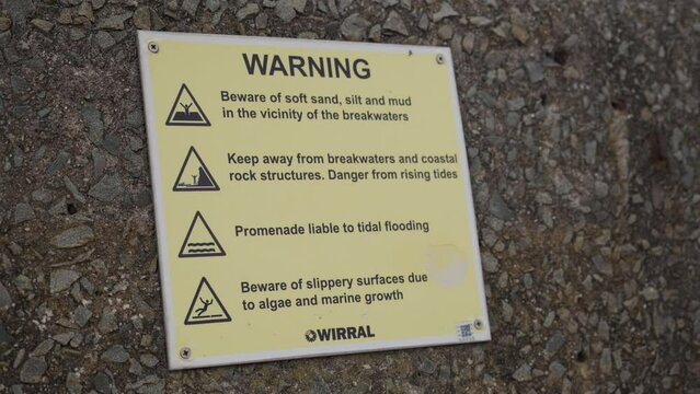 Warning sign on promenade on the Wirral in the UK