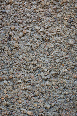 close-up macro view of sand and cement mix grainy concrete wall surface, concrete mixture made of...