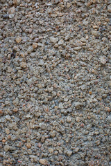 close-up macro view of sand and cement mix grainy concrete wall surface, concrete mixture made of too much sand or too little cement, abstract background or backdrop texture