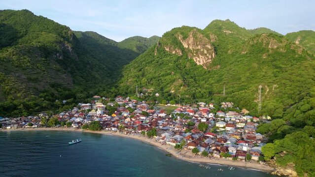 Gorontalo, Indonesia: Cinematic aerial drone footage of leato selatan village just outside Gorontalo by the Celebes sea in the Sulawesi island in Indonesia. 