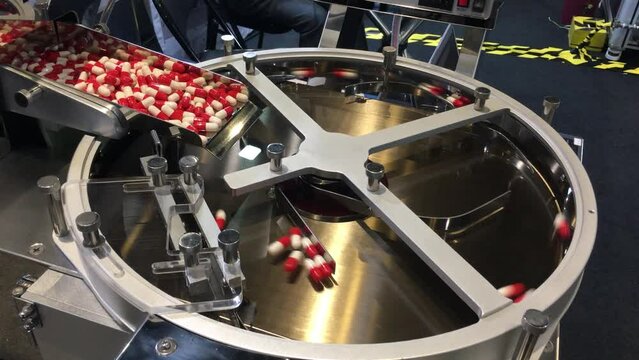 AI powered and controlled robotic medicine capsules and tablets packaging machine working in an open public demonstration
