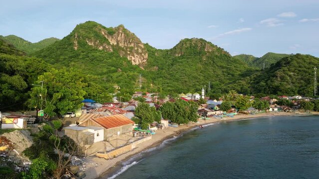 Gorontalo, Indonesia: Cinematic aerial drone footage of leato selatan village just outside Gorontalo by the Celebes sea in the Sulawesi island in Indonesia