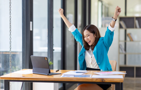 Excited Happy asian woman sit at desk feel euphoric win online, happy asian woman overjoyed get mail at laptop being promoted at work, biracial girl amazed read good news at computer